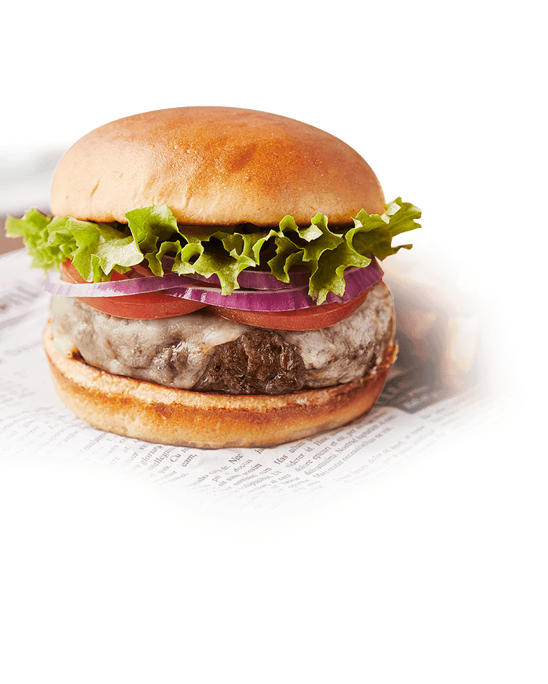 A freshly cooked cheeseburger served on a brioche bun with fresh lettuce, onion slices and tomato slices.